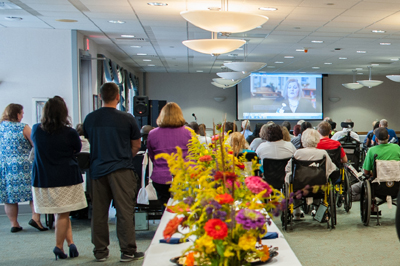 Patients, employees and family members listen intently to the stories of recovery shared by four former Bryn Mawr Rehab patients