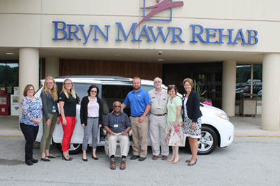A group of people posing with the new Sienna van from Team Toyota of Glen Mills
