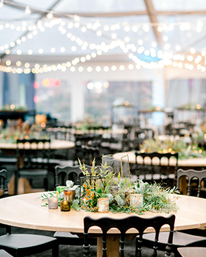 View over event room of tables with overhead string lighting