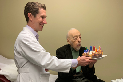 Matthew Goldstein, MD (left) celebrates patient's 100th birthday with him