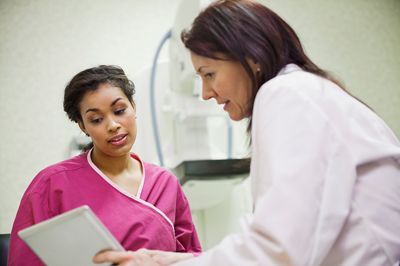 Technician with mammogram patient going over information