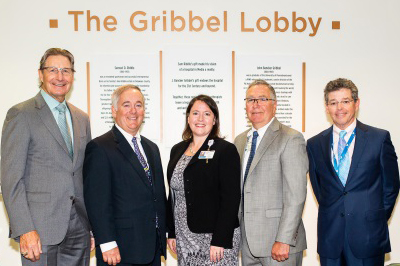 Leadership at Riddle Hospital, Main Line Health, posing for a photo in the newly christened Griddle Lobby