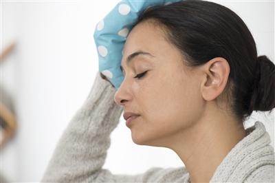 Woman holding ice pack to head