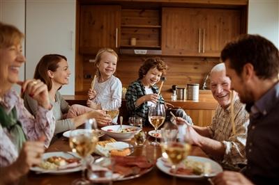 Extended family enjoying meal at table