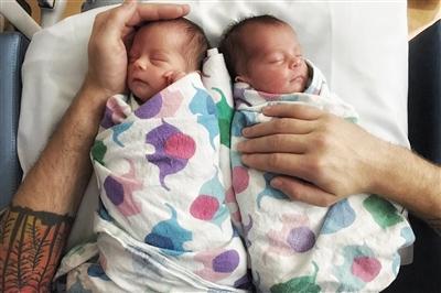 Two newborns swaddled and sleeping