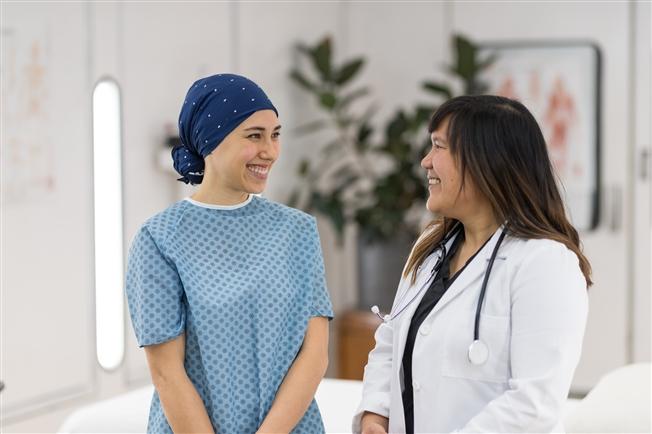 Breast cancer patient talking with doctor in hospital office setting