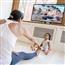 Woman exercising in her living room with toddler
