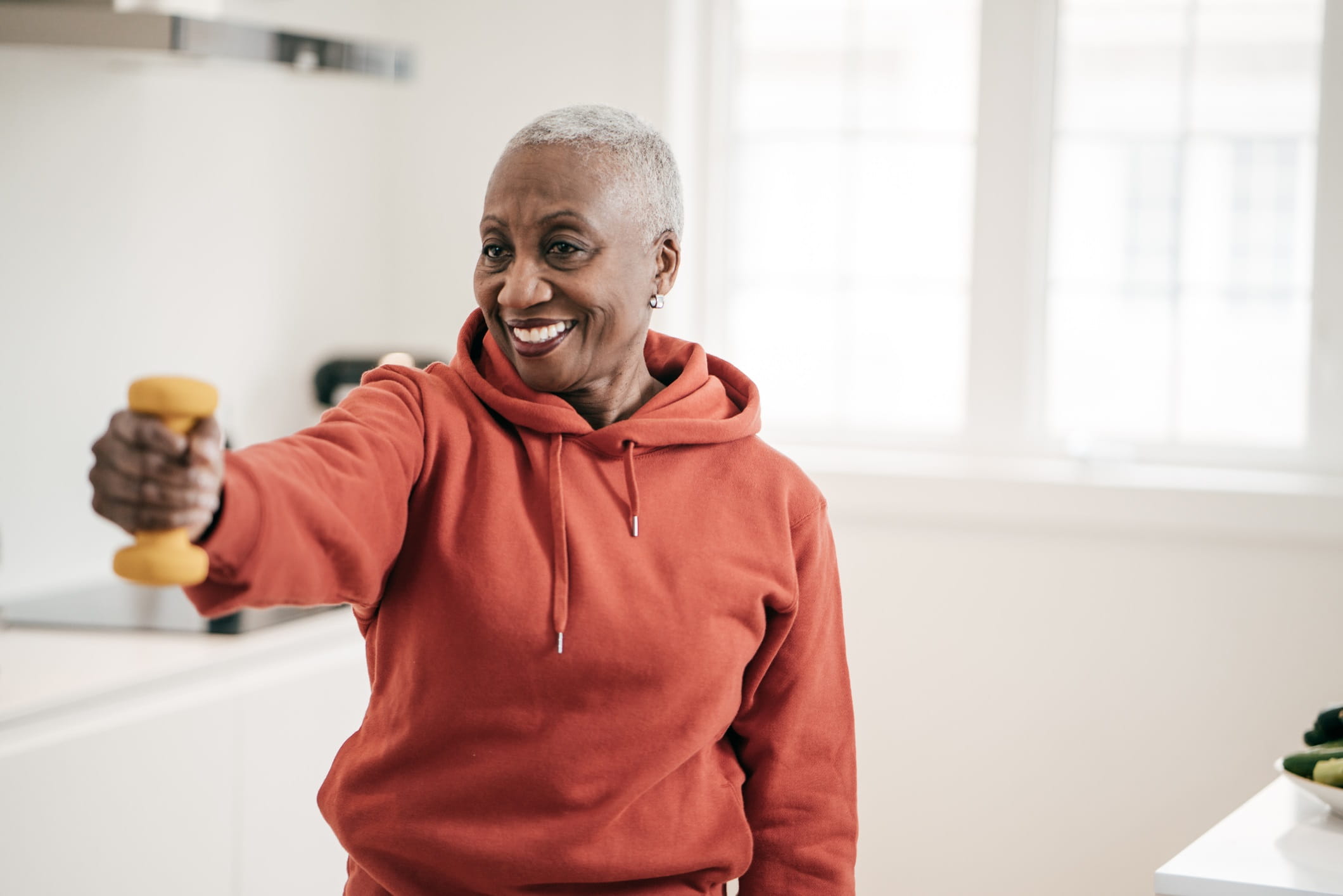 Senior women taking care of herself she exercise with dumbbells at home