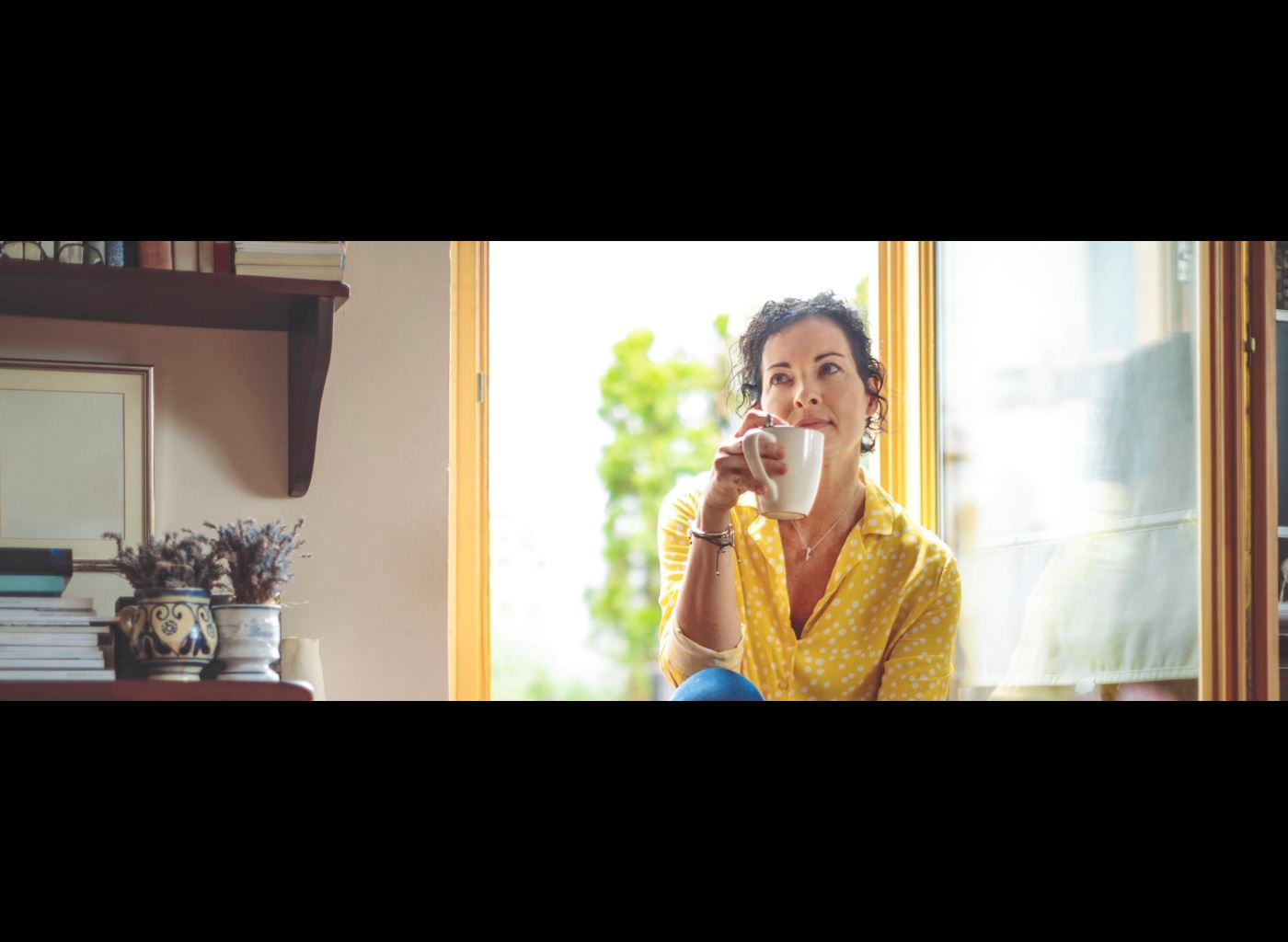 Mature woman is having the morning coffee at home