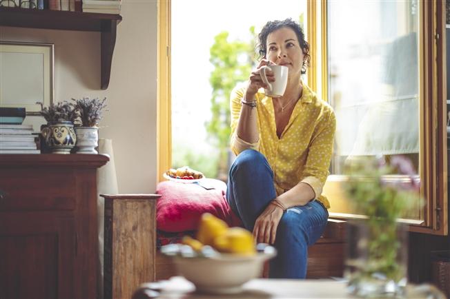 Mature woman is having the morning coffee at home
