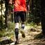 Runner in the forest wearing compression stockings on calves