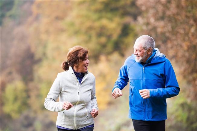 Mature older couple exercising outside together