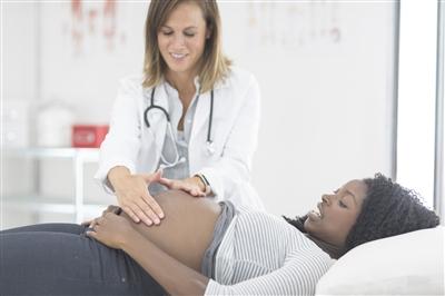 Pregnant woman at check up with female doctor
