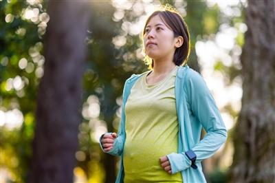 Pregnant woman jogging in park