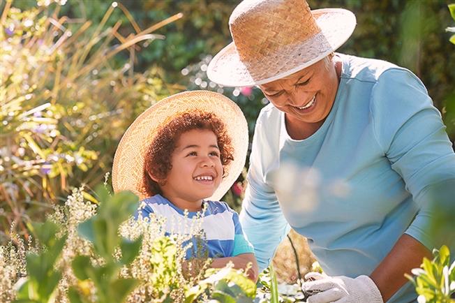 Grandmother and child gardening outdoors