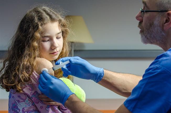 adolescent girl receiving vaccine