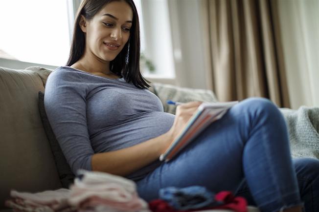 pregnant woman making notes