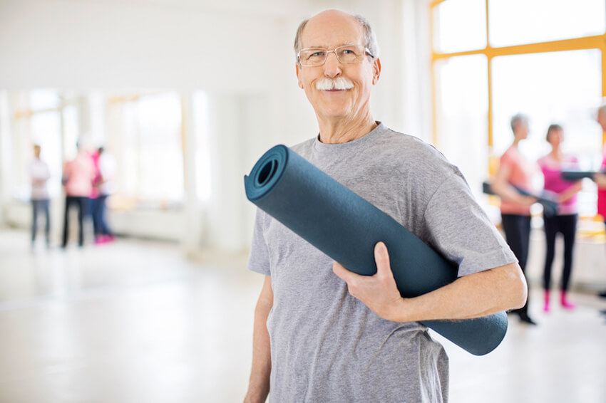 Older man with yoga mat
