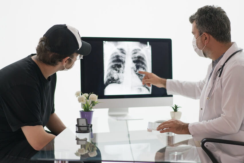 man discussing cancer screening with doctor