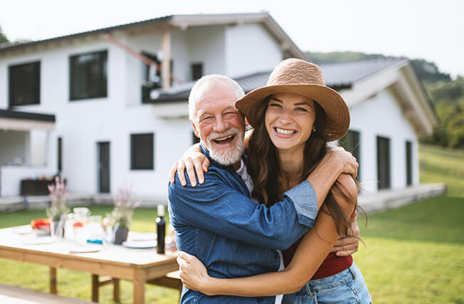 Photo of older man with younger woman laughing
