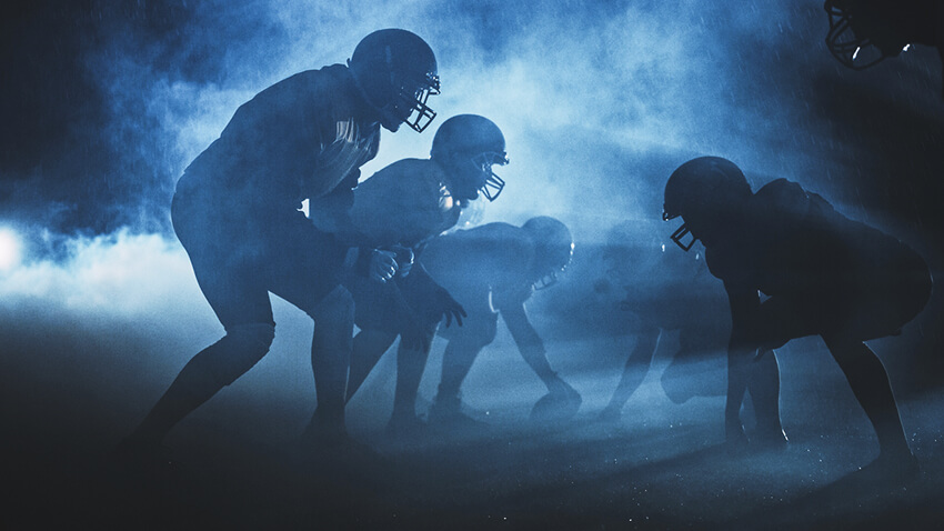 Football team on the football field in the dark.