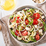 Greek style spiralized zucchini salad with tomato feta olives cucumber.