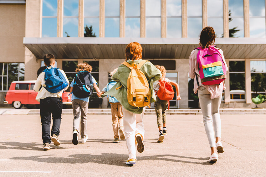 Children running into a school.