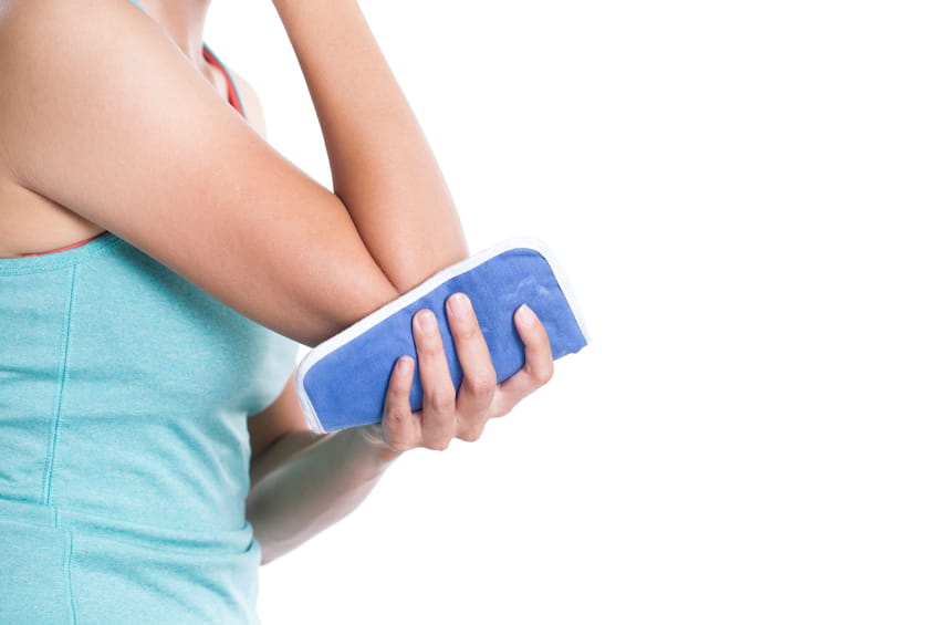 woman holding ice pad to elbow