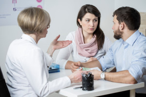 couple conversing with doctor