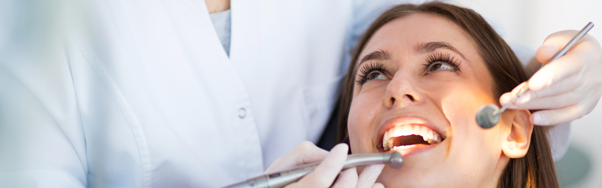 women getting teeth checked by dentist