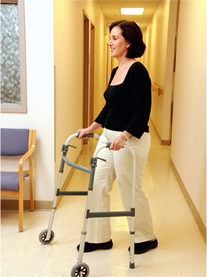 Demonstrating technique for using walker with wheels
