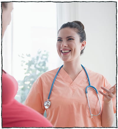 Cheerful nursing talking pregnant woman