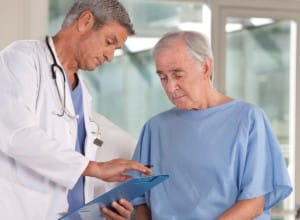 male doctor and patient conferring over paperwork