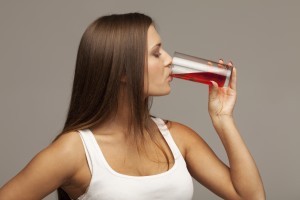 woman drinking red juice